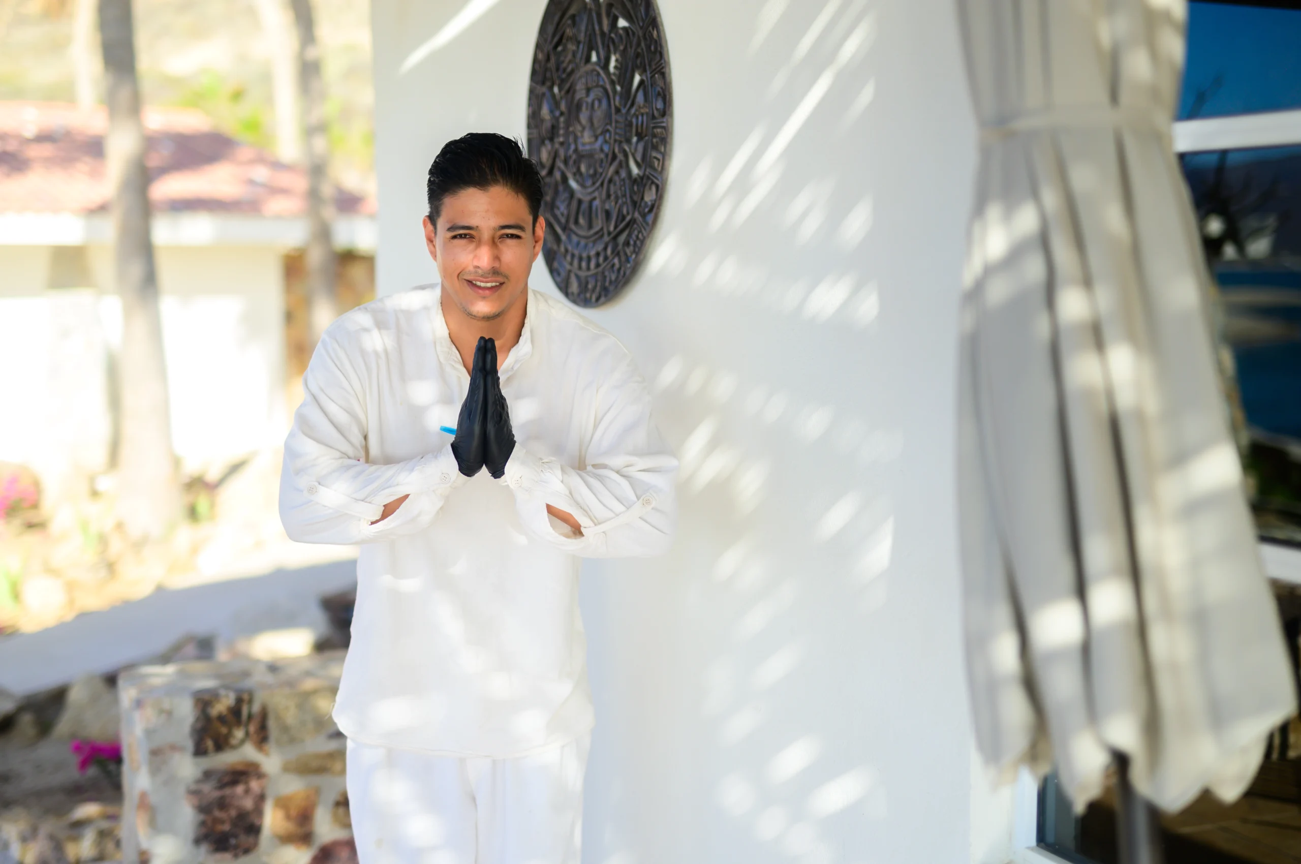 Carreras 1 a man in white clothes standing in front of a wall